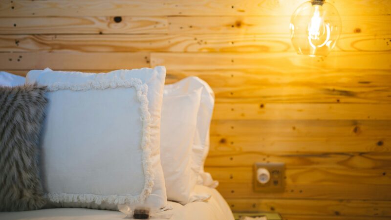 A bedroom with soft light and hardwood floor
