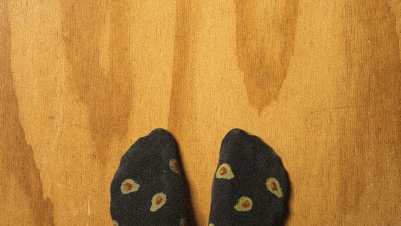 Feet with socks on hardwood flooring in a GTA home.