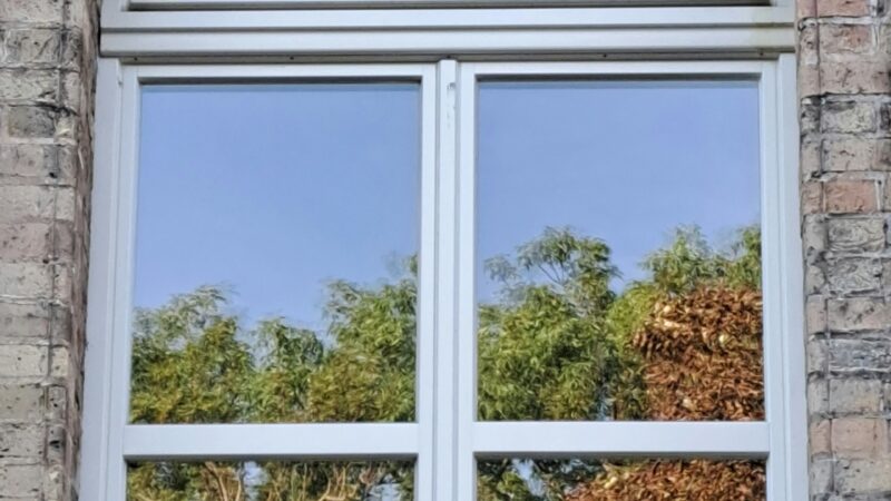 A tilt and turn window on a stone siding house