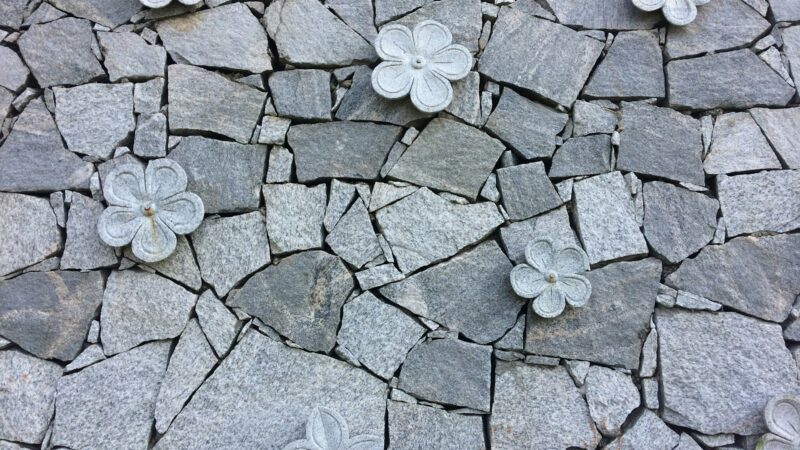 Beautiful stone wall with flowers thanks to stone veneer installation manual