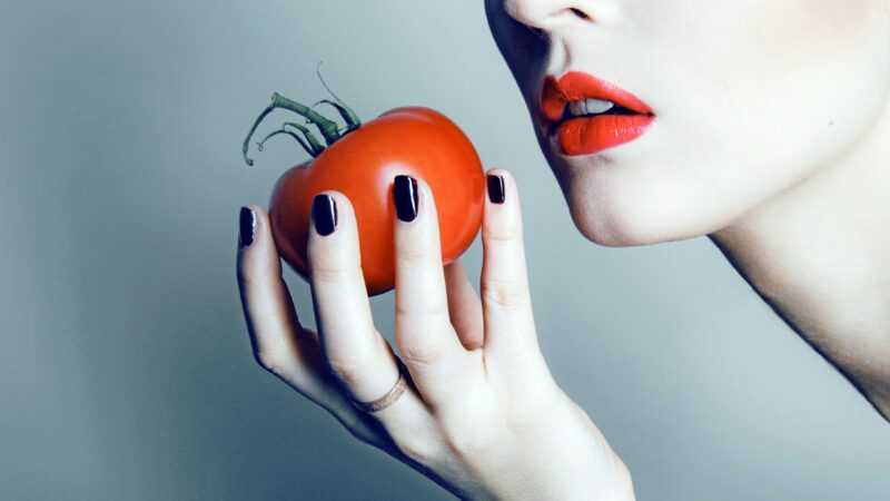 Woman with tomato in her hand